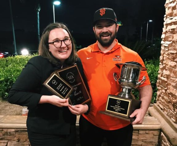 debate team members holding awards